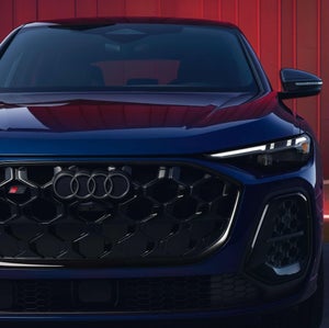 Front facing profile view of an Audi SQ5 parked.